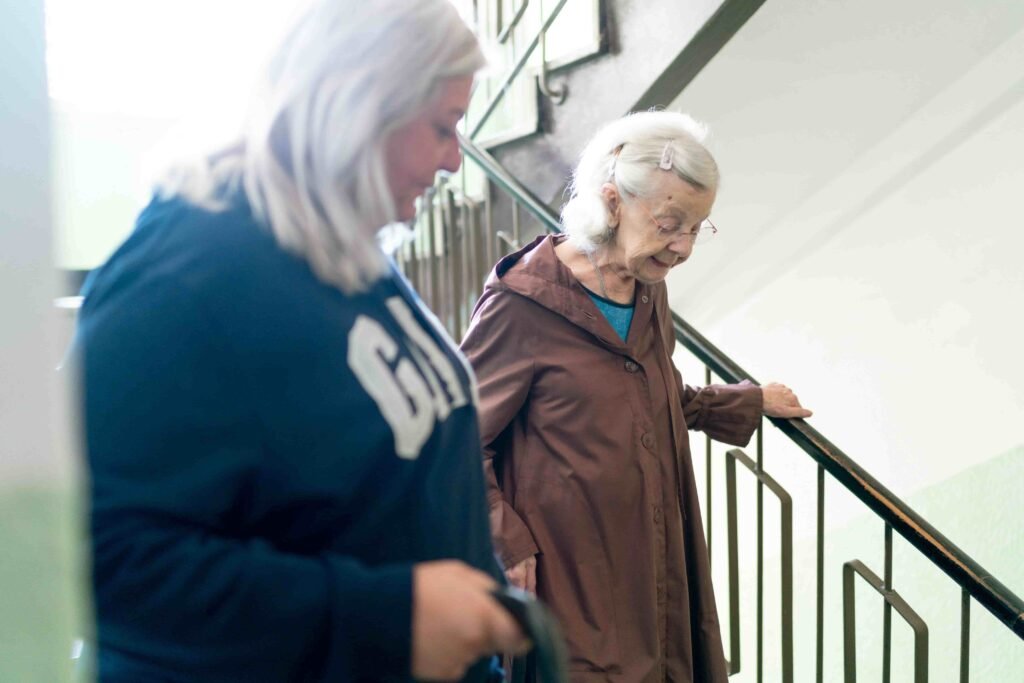 phoenix caregiver helping keep aging parent safe down the stairs